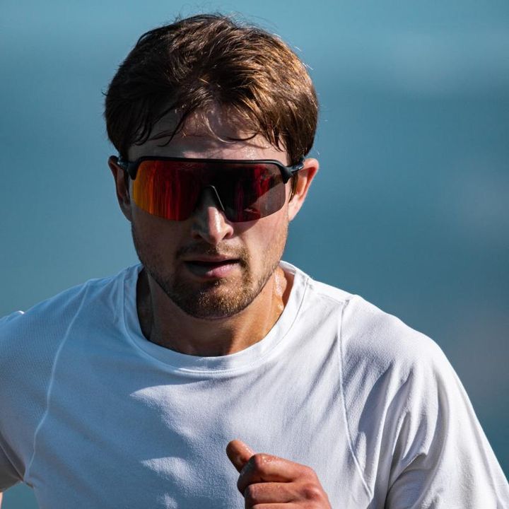 Alpe sports glasses worn by one of our athletes, featuring a lightweight design with fog-resistant lenses, providing optimal fit and clarity during intense activities.